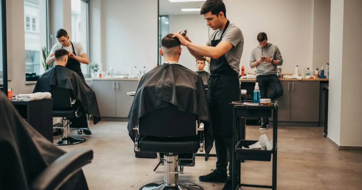 Students training in a barber program